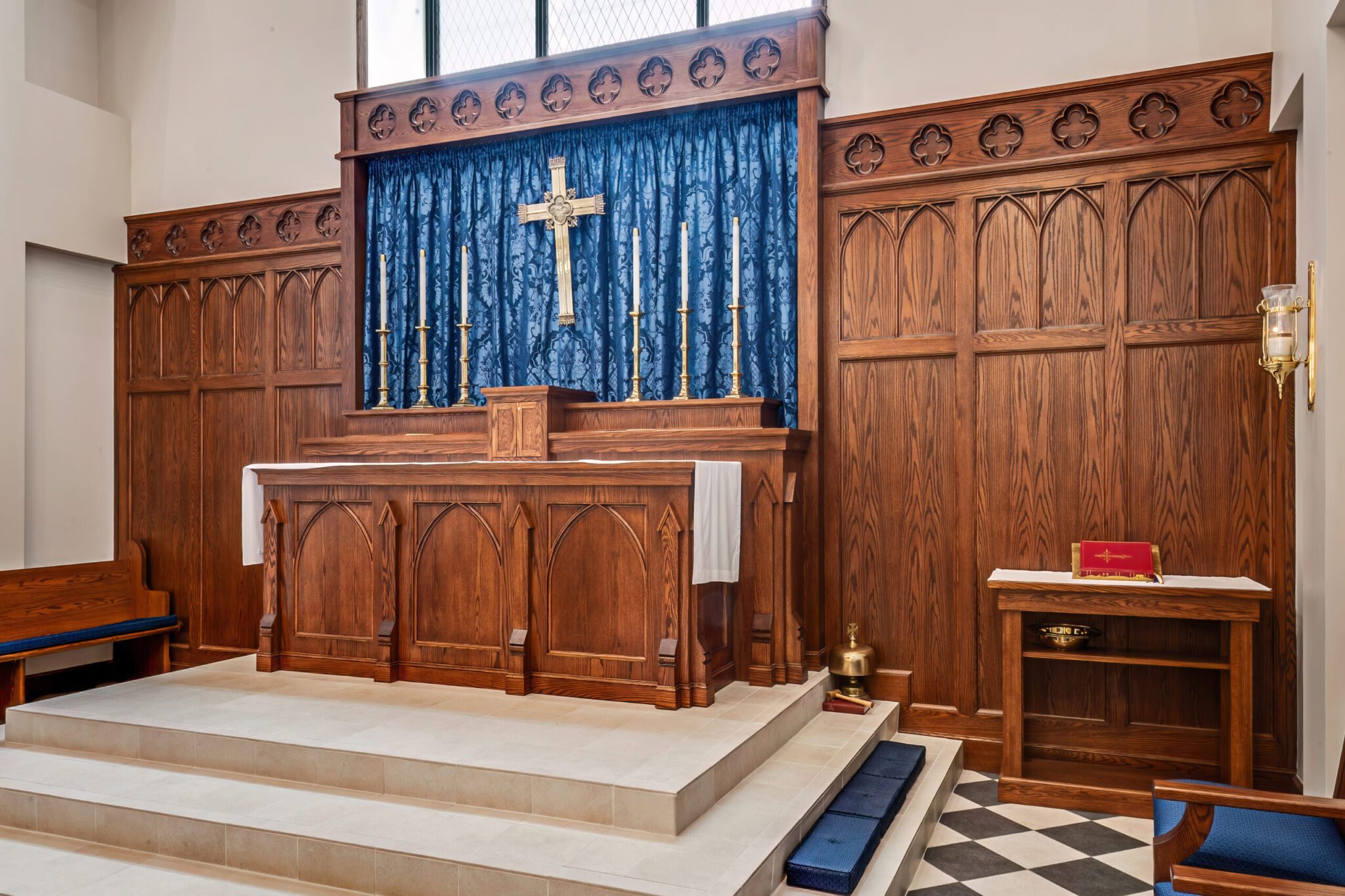A warm English Gothic altar with retable and tabernacle.